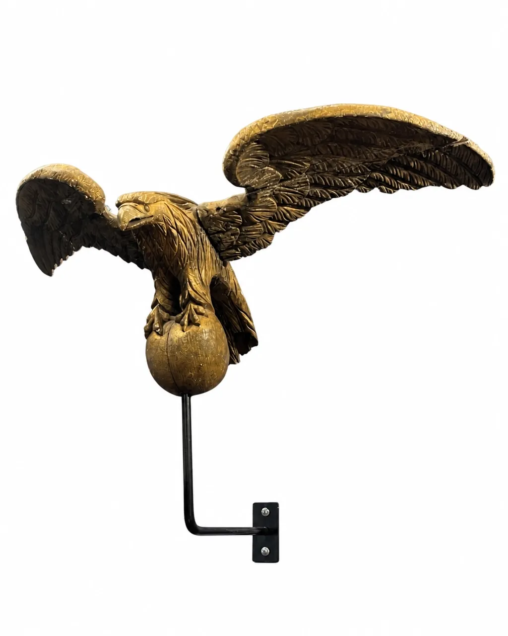 Carved eagle weathervane with globe and support isolated on a white background