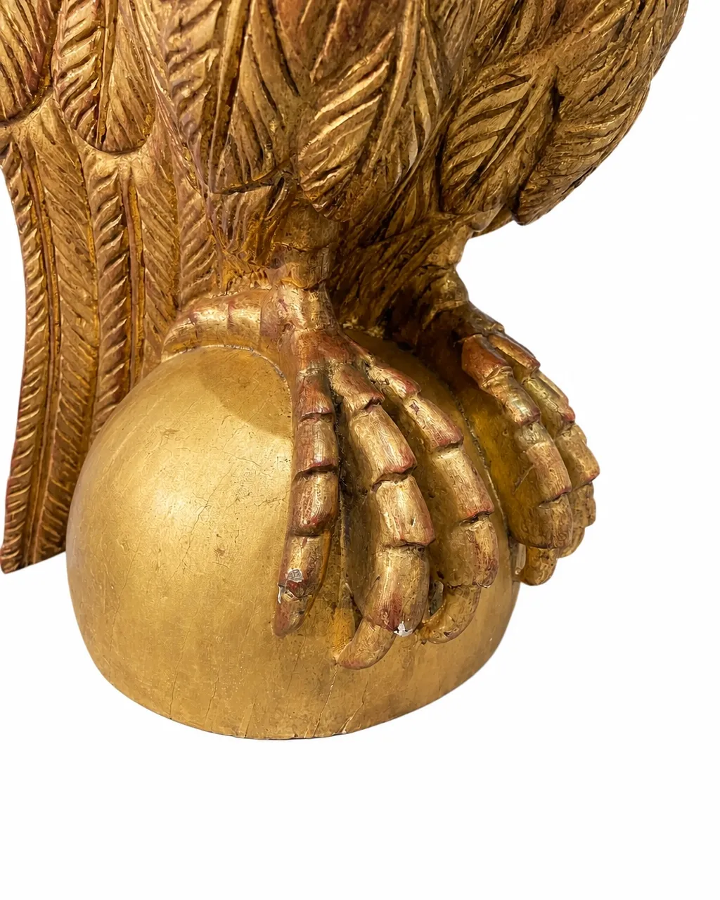 Detail of gilded eagle talons gripping a wooden sphere