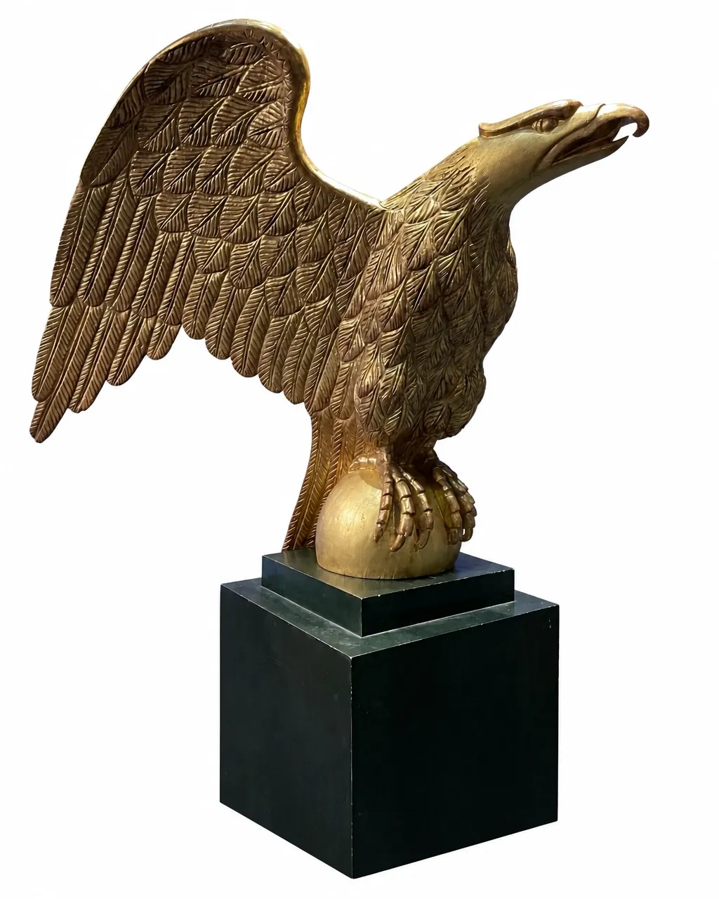 Gilded eagle sculpture perched on a globe, isolated on a clean white background