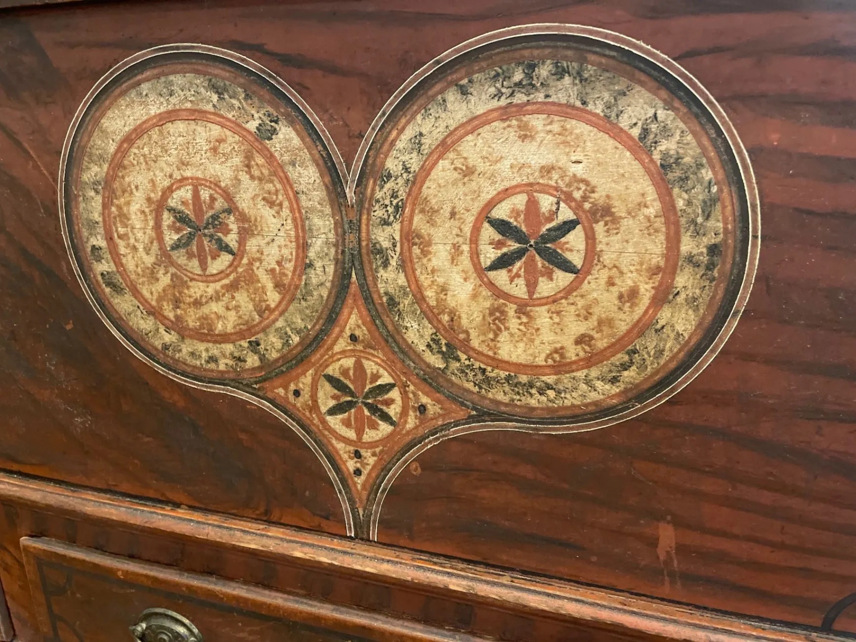 Detail of the painted decoration and fancy grain on the chest front