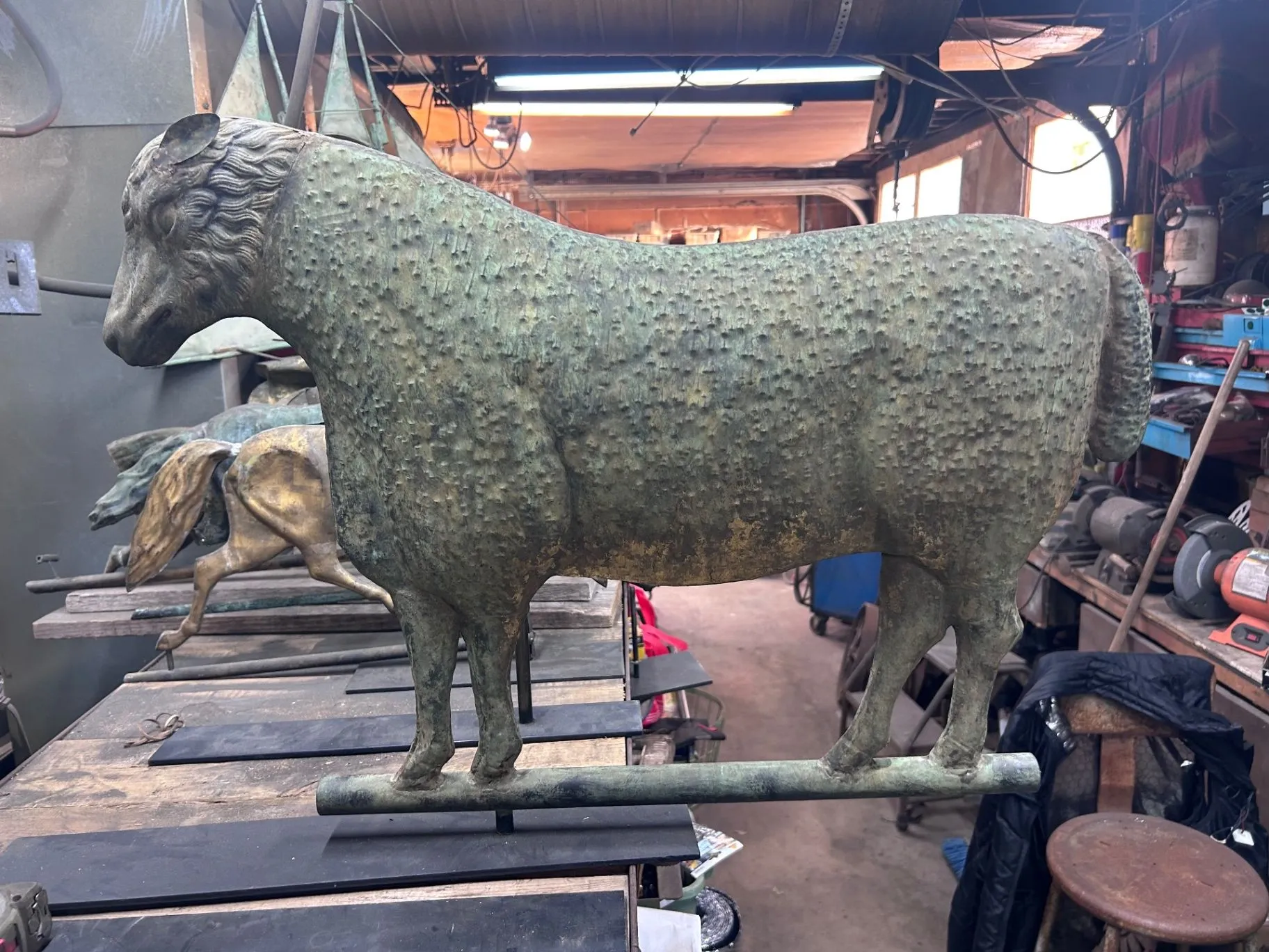 Side view of the complete copper full-bodied sheep weathervane with its support