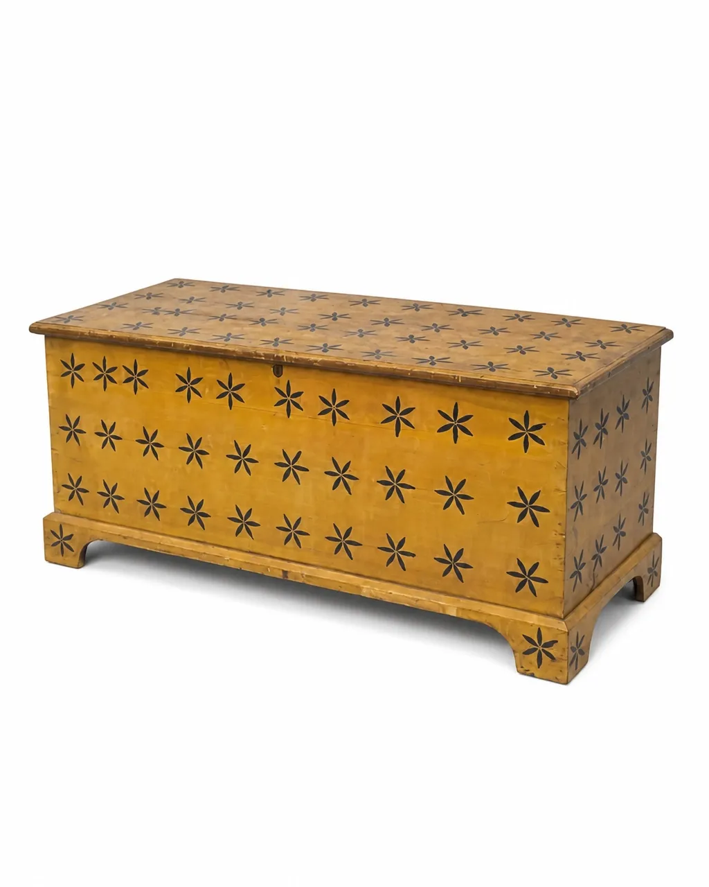 Yellow decorated chest with tumbling compass-star decoration, isolated on a clean white background
